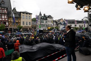 Kevin Estre, Ayhancan G&cedil;ven, Thomas Preining, Manthey, adenau, nurburgring, market square, germany, rainy, cloudy, portrait, event, crowd, car, team crew, marshals, winward racing, wide angle, close-up, excitement, focus, tension
 | Gruppe C Photography
